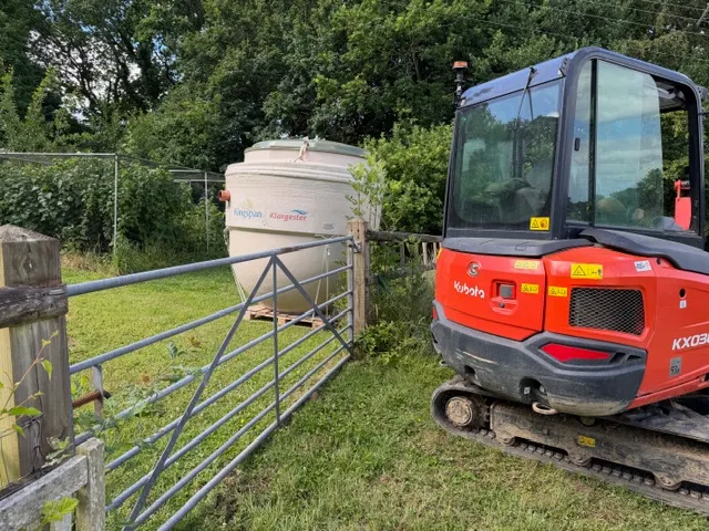 Treatment plant and excavator arriving at a domestic installation site